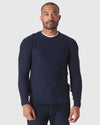Man wearing Heather Navy Pique Crew Sweater over white T-shirt.