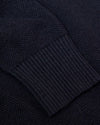 Heather Navy Pique Crew Sweater close-up, showcasing ribbed cuff and textured knit.