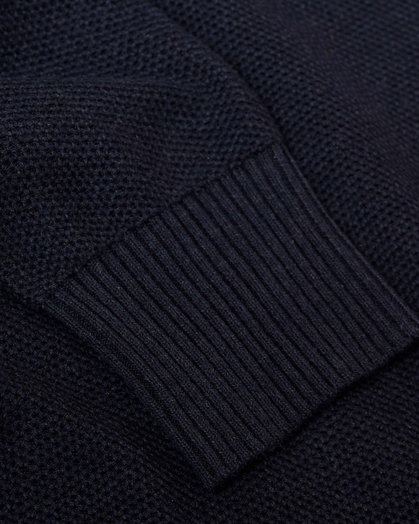 Heather Navy Pique Crew Sweater close-up, showcasing ribbed cuff and textured knit.
