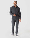 Man in Charcoal Heather Gray Long Sleeve Ripstop Commuter Shirt stepping forward.