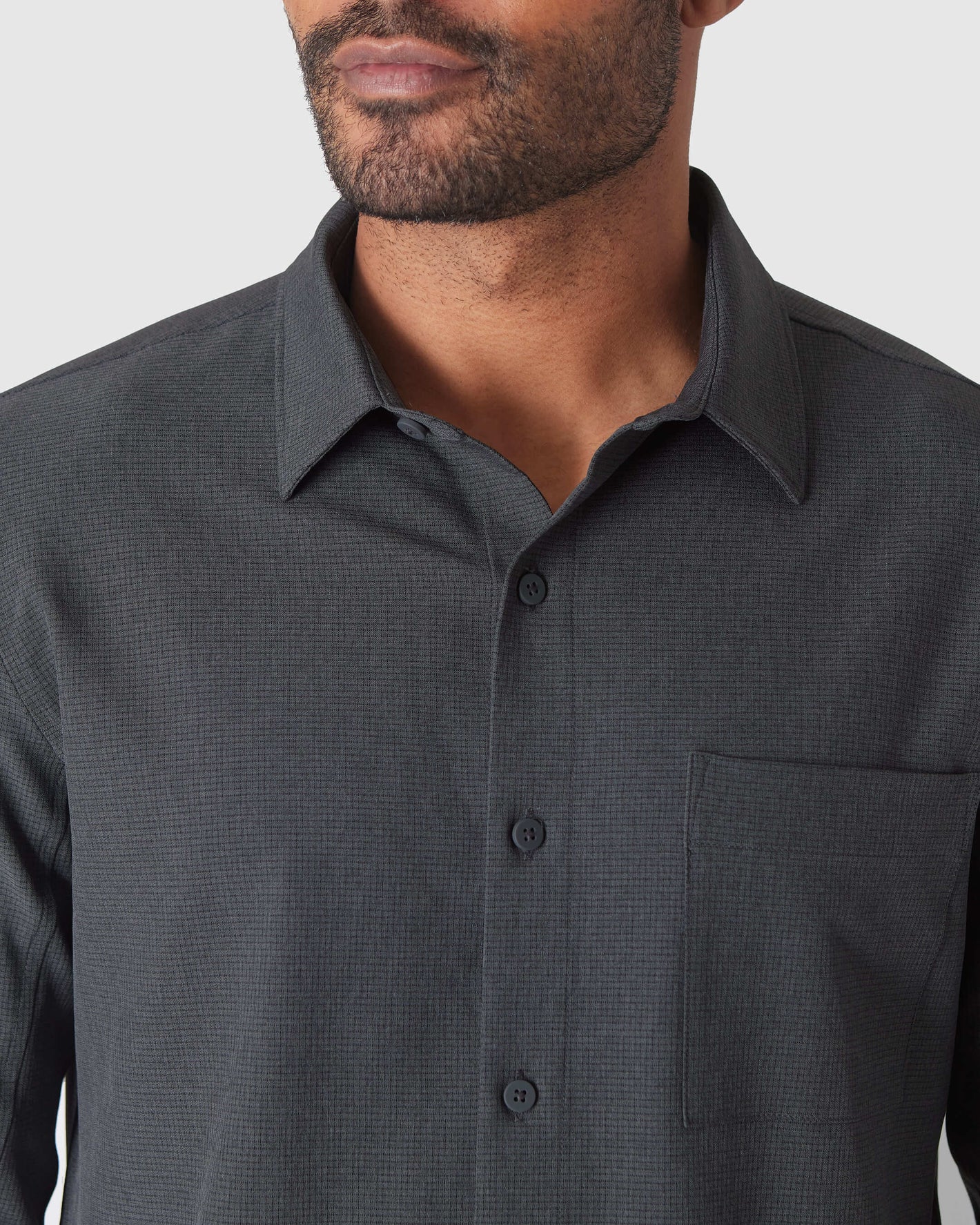 Man wearing Charcoal Heather Gray Long Sleeve Ripstop Commuter Shirt.