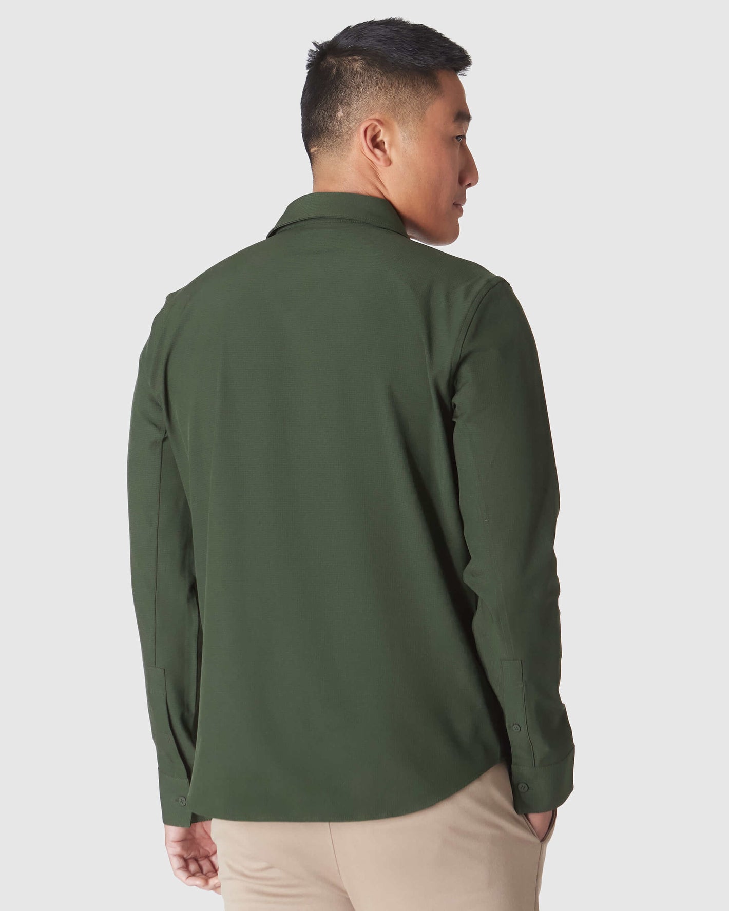 Man wearing Olive Long Sleeve Ripstop Commuter Shirt with khaki trousers.