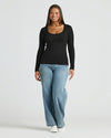 Woman wearing Womens Black Ribbed Long Sleeve Scoop Neck Tee.