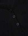 Close-up of Womens Black Waffle Long Sleeve Boxy Henley's button placket.