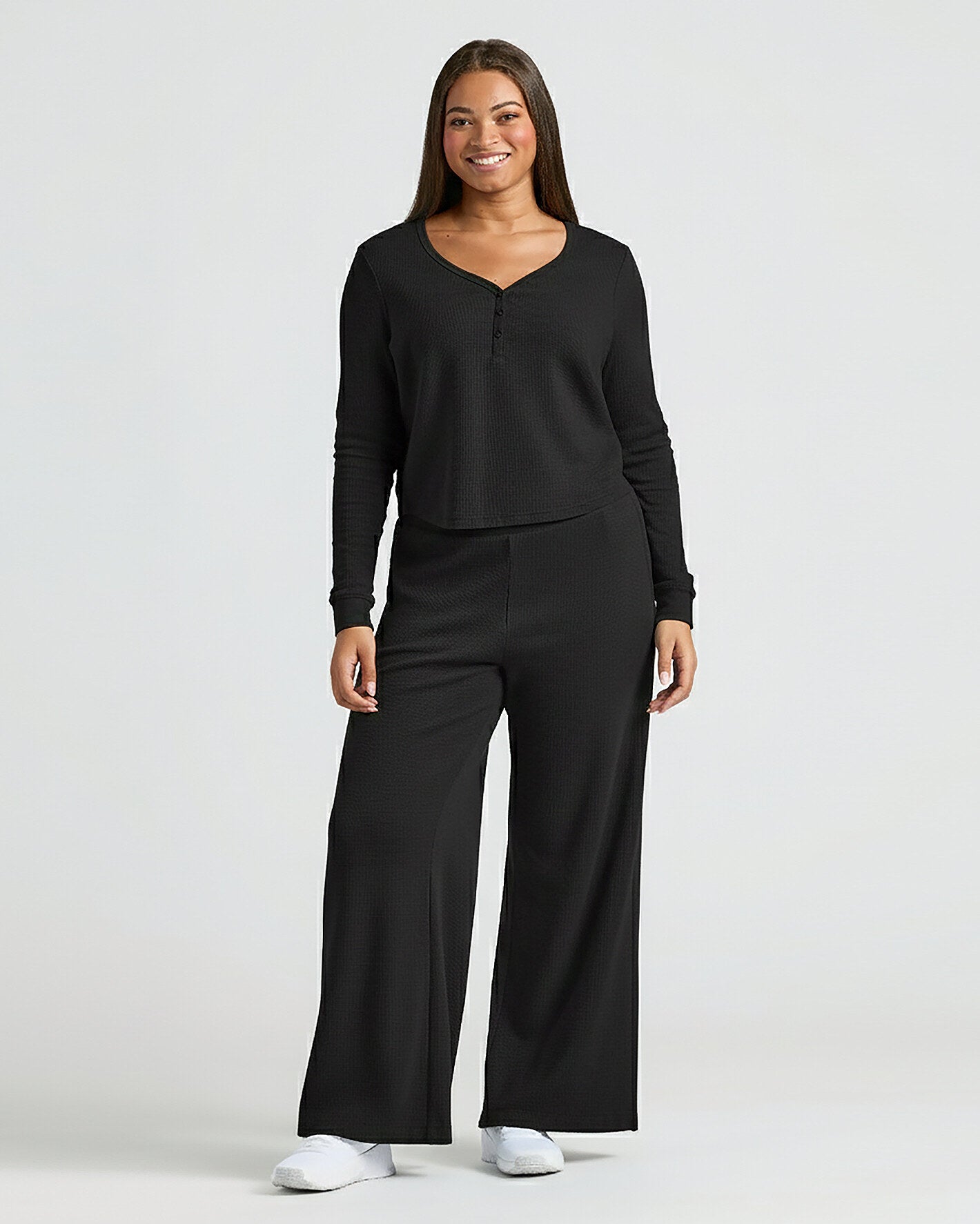 Woman in Womens Black Waffle Wide Leg Pants, modeling cozy lounge set.