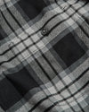 Onyx Plaid Long Sleeve Flannel Shirt close-up showing button and pocket seam.