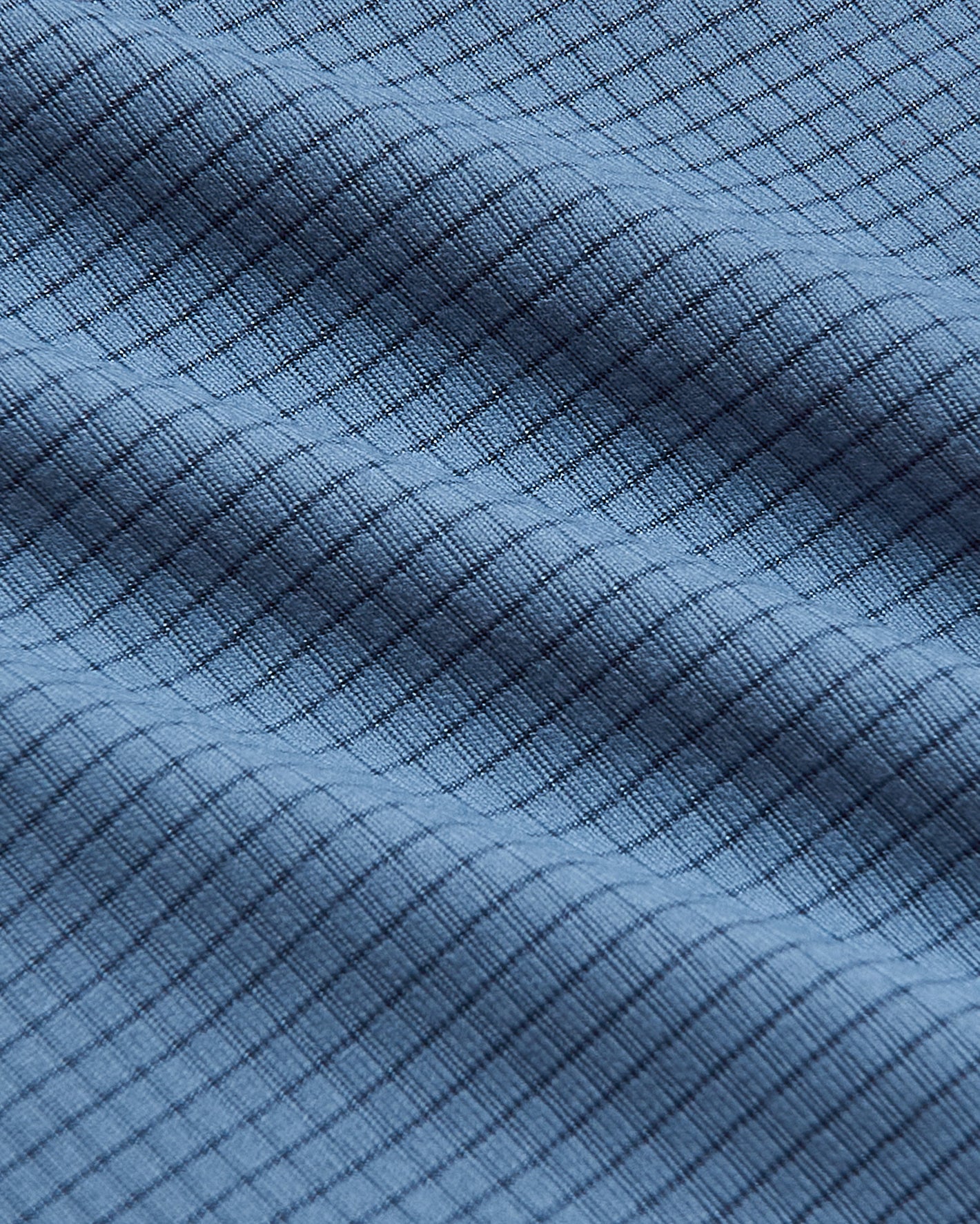 The Staple Sleeveless Active Mesh Tank's blue waffle texture close-up.