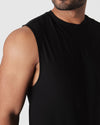 Black Active Sleeveless Muscle Tee on man, showcasing fit and shoulder design.