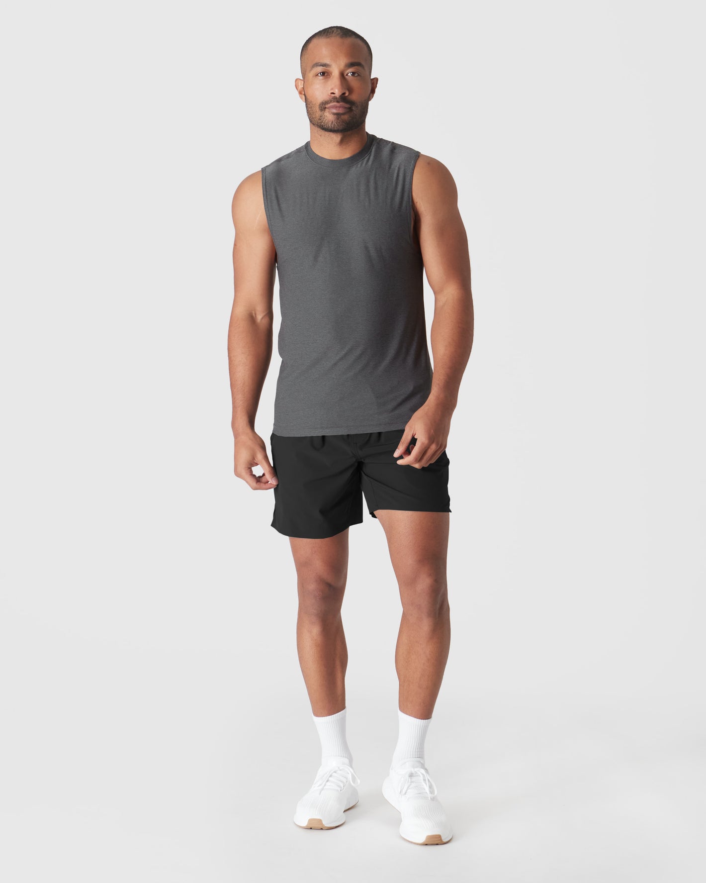 Man modeling Charcoal Heather Gray Active Sleeveless Muscle Tee with black shorts.