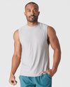 Man wearing Light Heather Gray Active Sleeveless Muscle Tee, posing confidently.