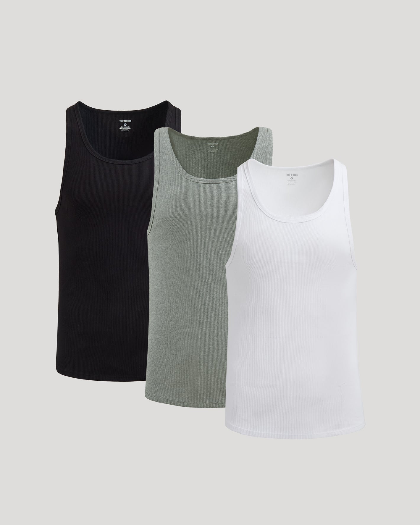Three tank tops in black, gray, and white on a light gray background