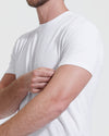Man wearing All-White Tall Straight Hem Crew Neck T-Shirt, adjusting sleeve.