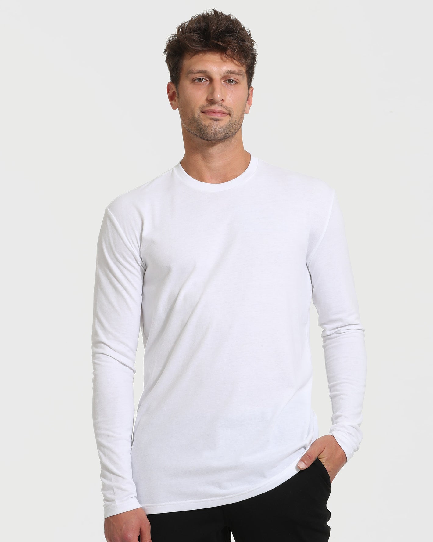 Young man in White Tall Long Sleeve T-Shirt, dark pants.