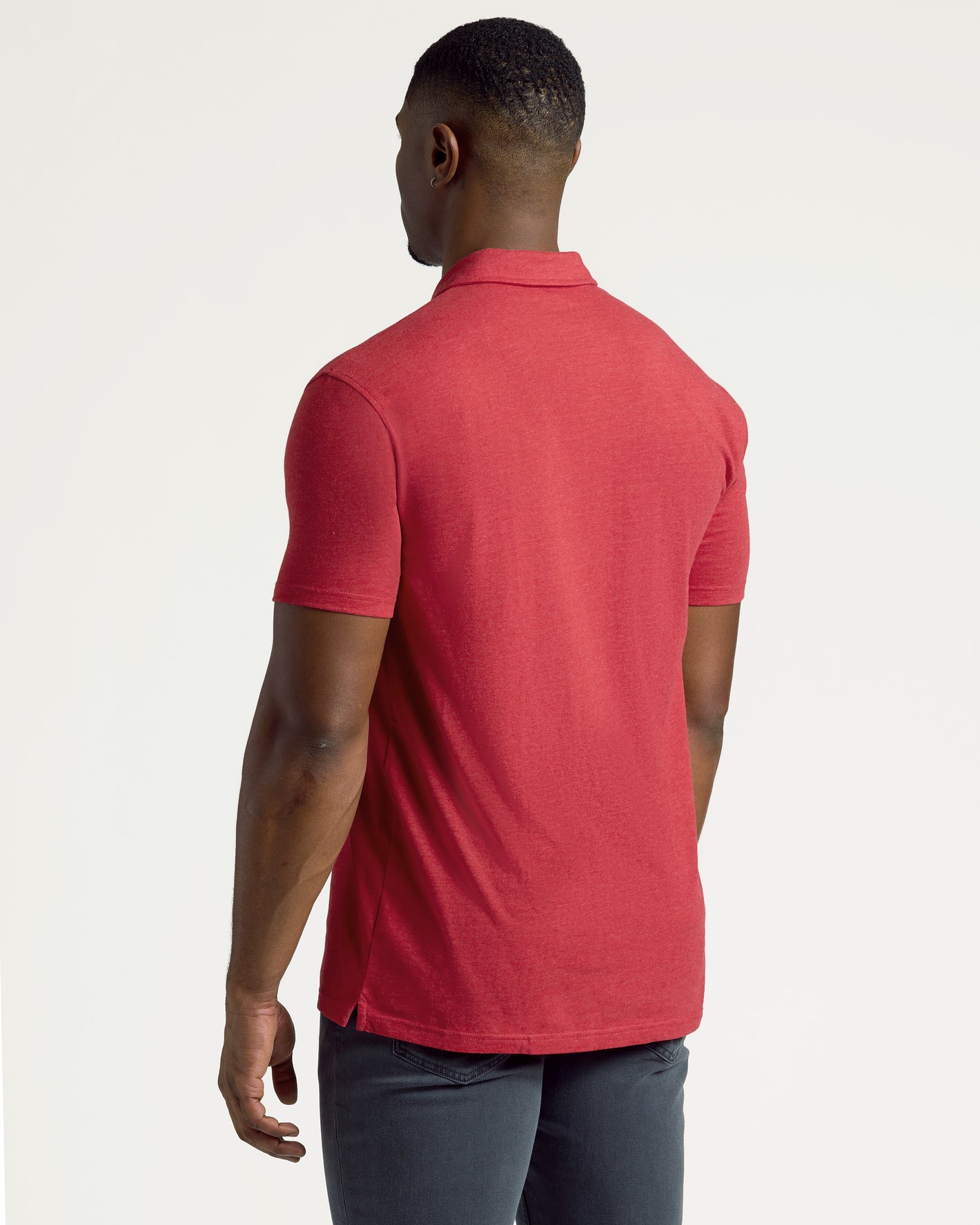 Back view of a man in a Dark Heather Lava Short Sleeve Tall Polo.