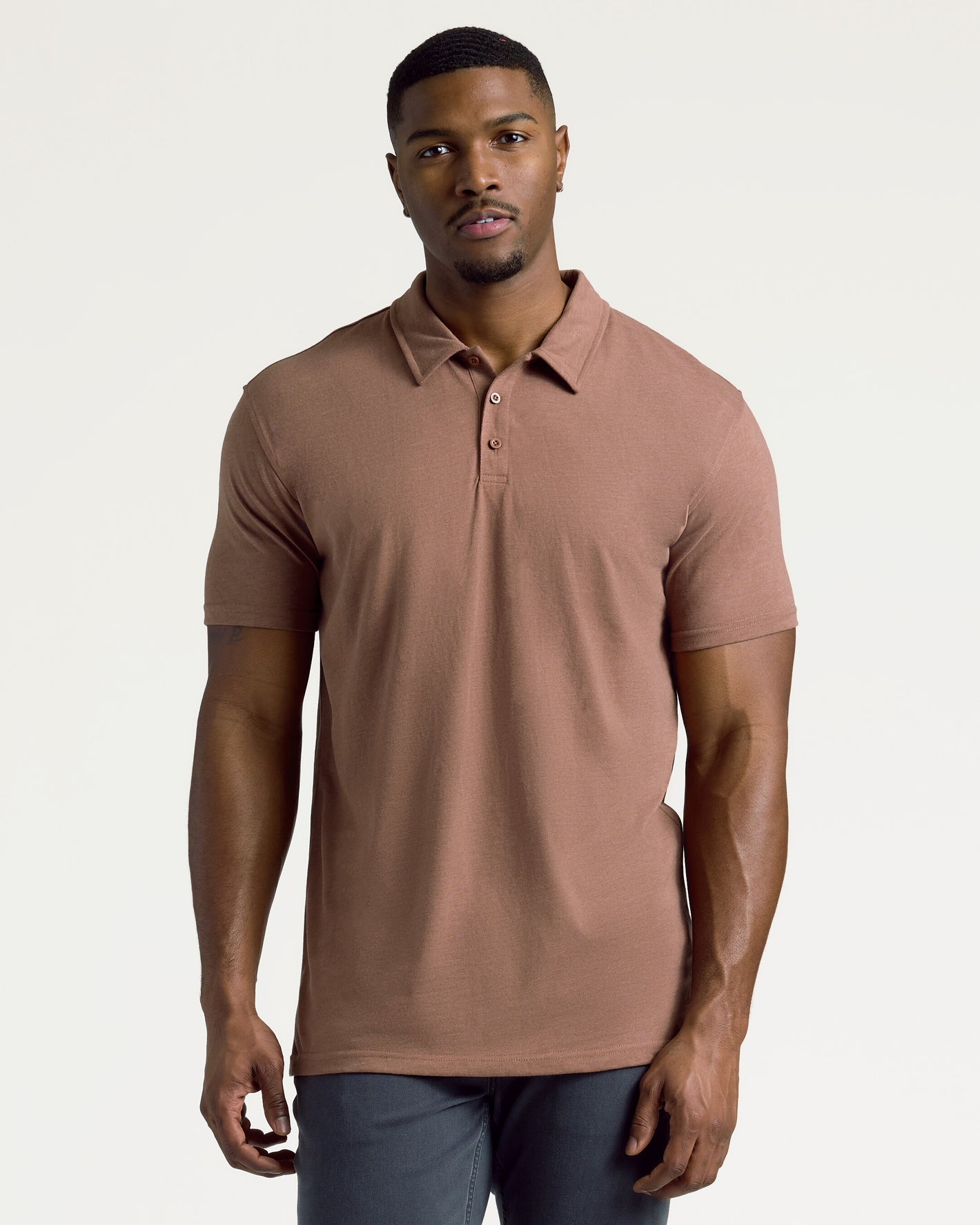 Young man modeling Dark Heather Sepia Short Sleeve Tall Polo.