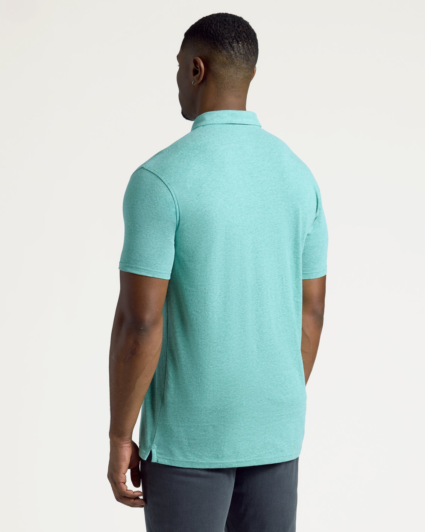 Person wearing Light Heather Greenery Short Sleeve Tall Polo, showcasing its perfect fit.