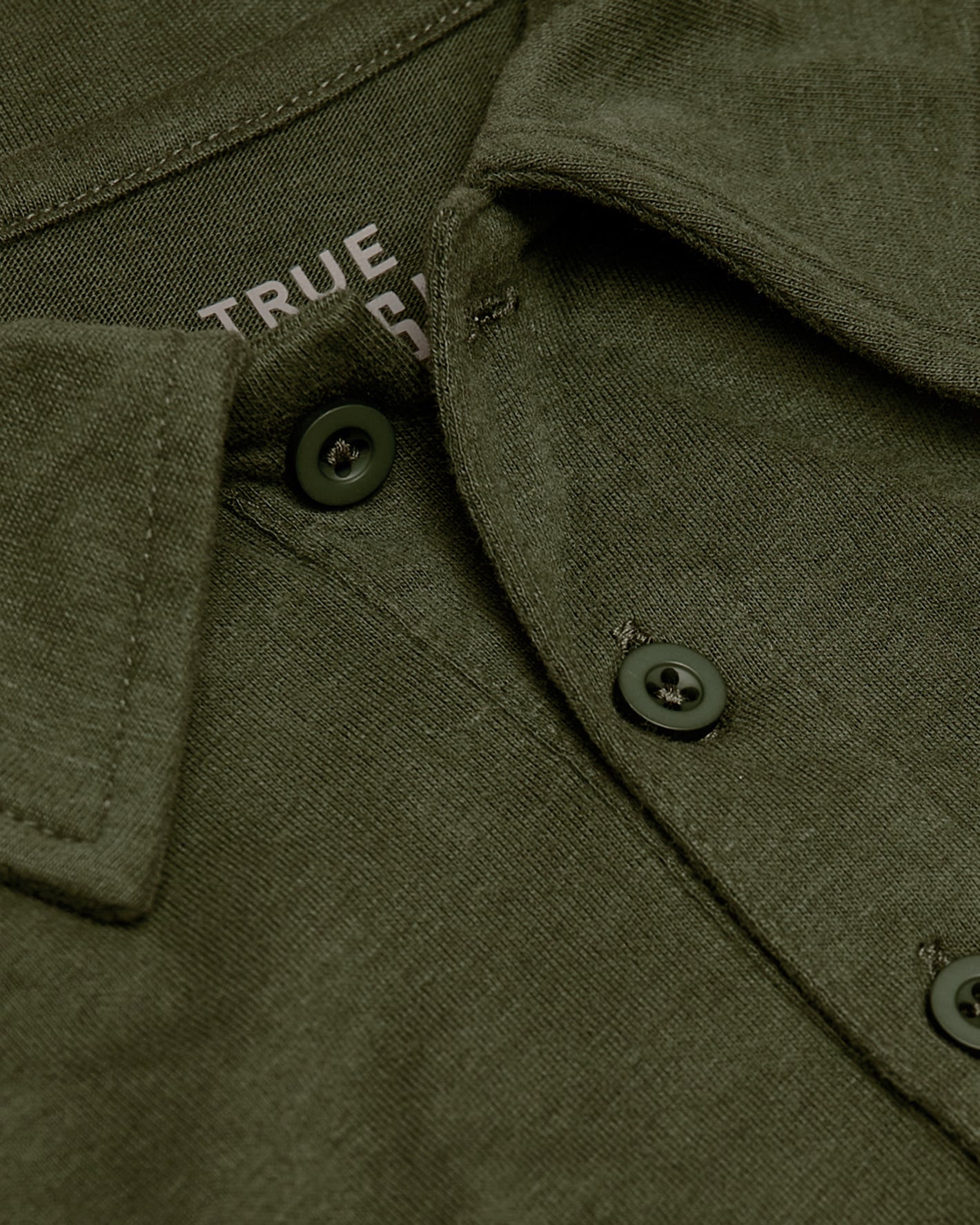 Military Green Short Sleeve Tall Polo's collar and buttons, showcasing texture.