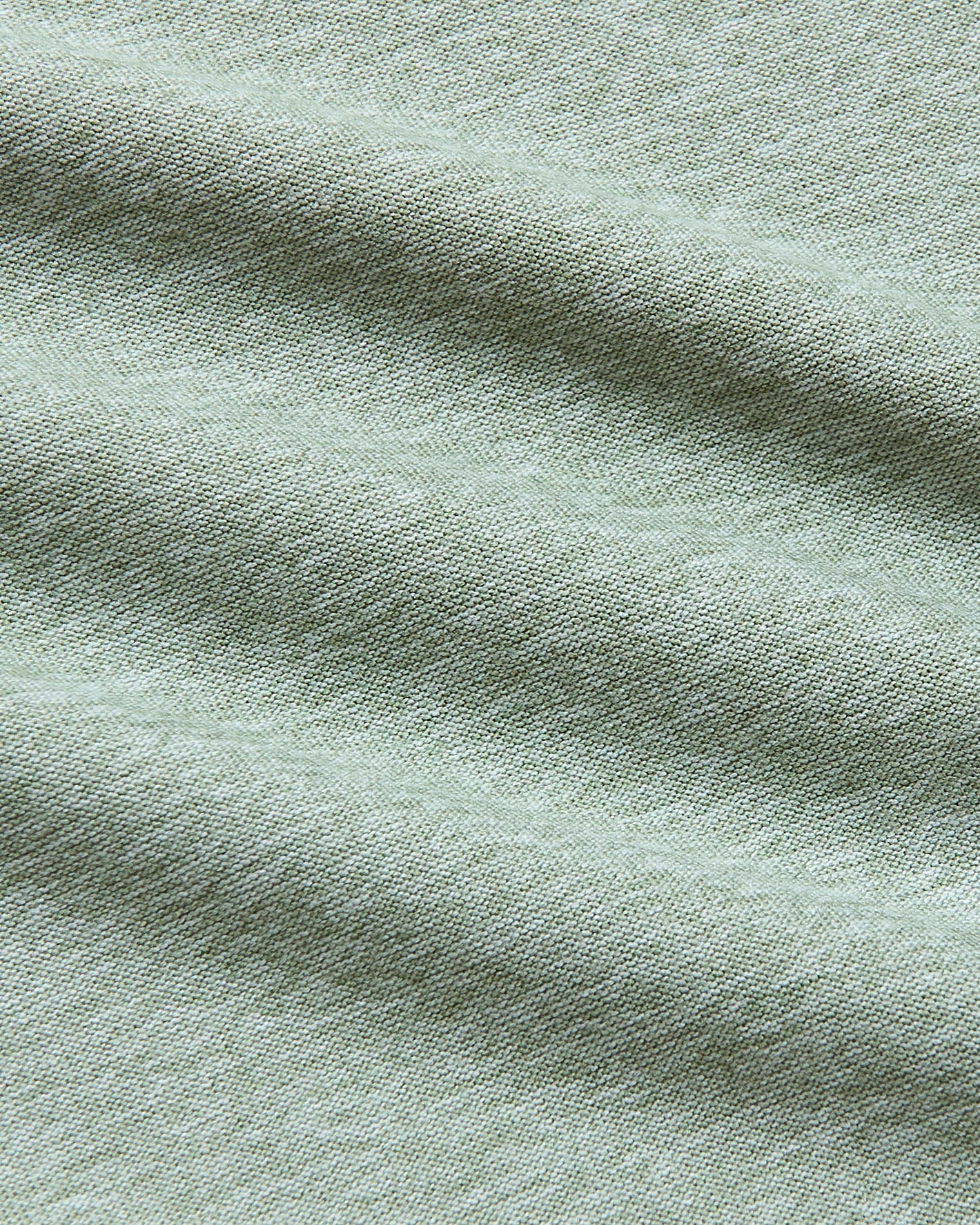 Lichen Tall Active Crew Neck 2.0, close-up of woven sage-green fabric.