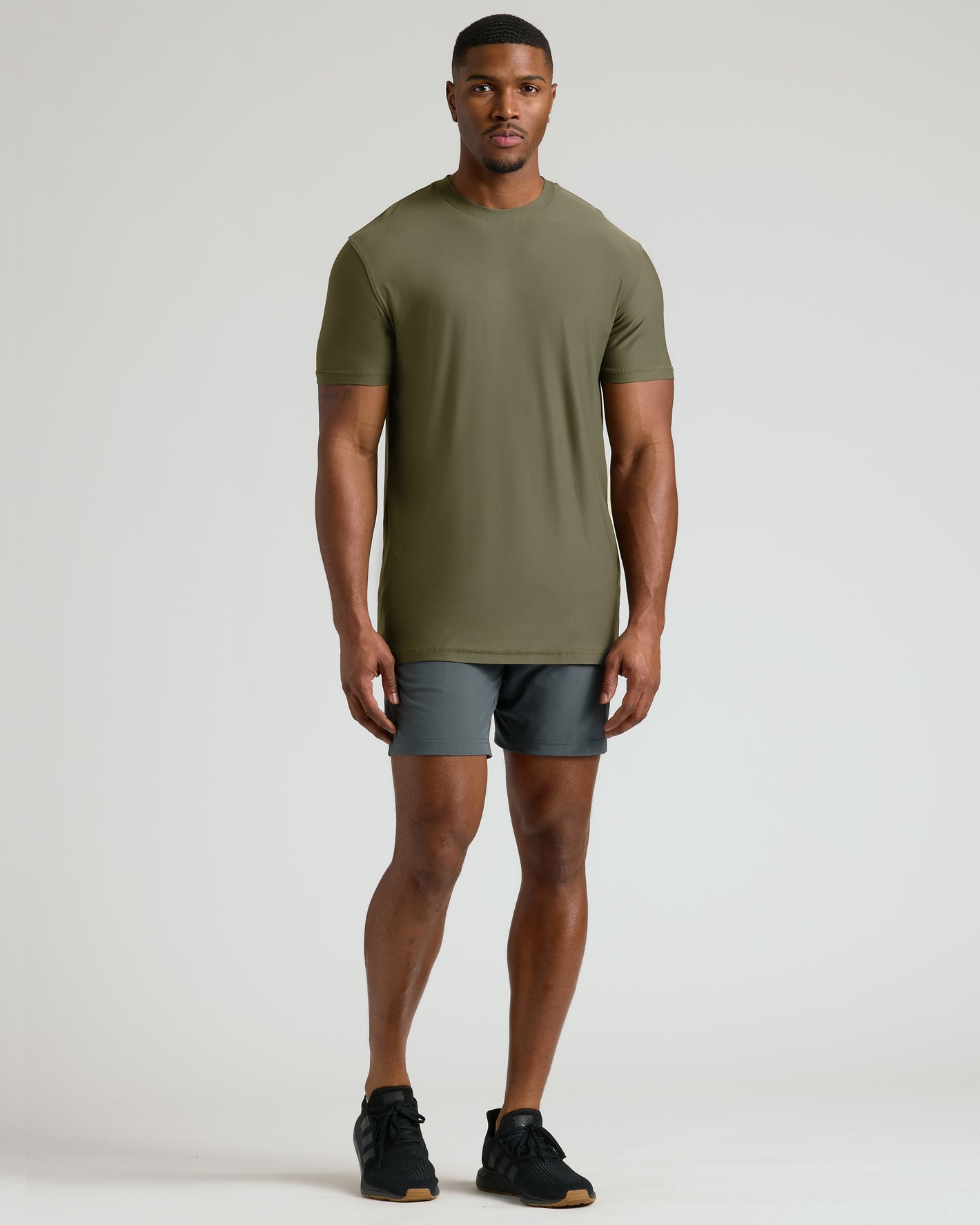 Military Green Tall Active Crew Neck 2.0 on young man standing.