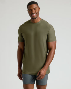 True ClassicTall Active Crew 3-Pack model in olive-green tee and gray shorts, smiling.