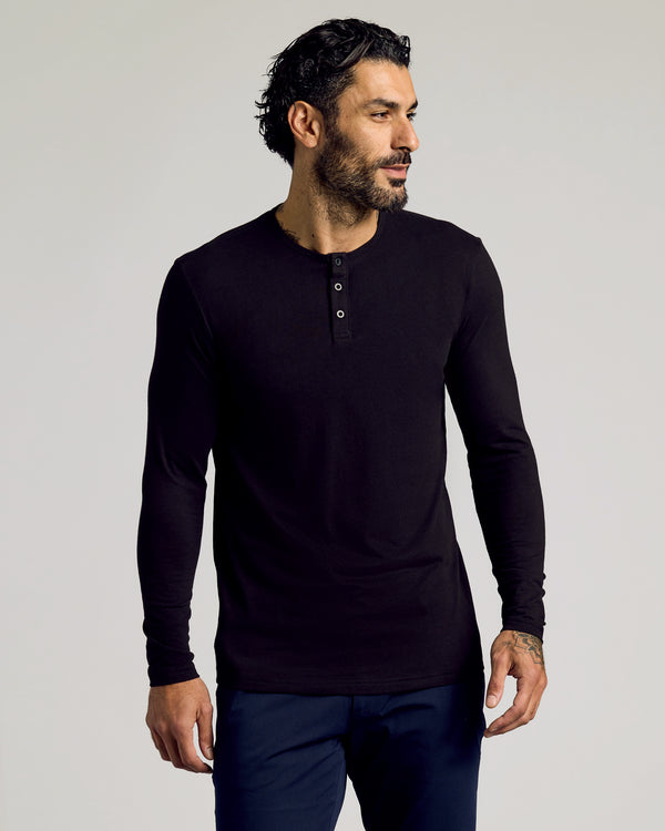 Man in Black Tall Classic Long Sleeve Henley with tattooed hand.