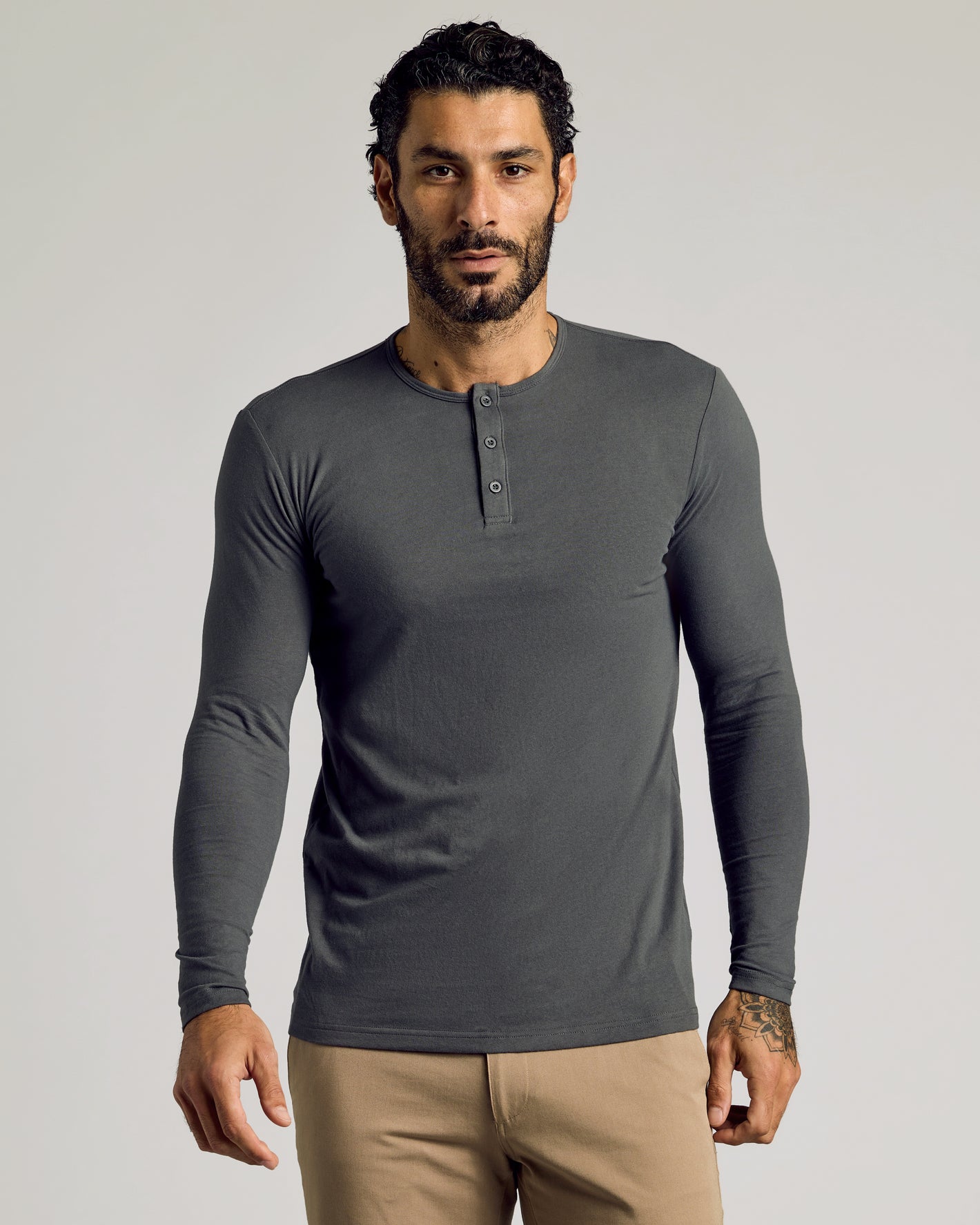 Model wearing Carbon Tall Classic Long Sleeve Henley with button placket.
