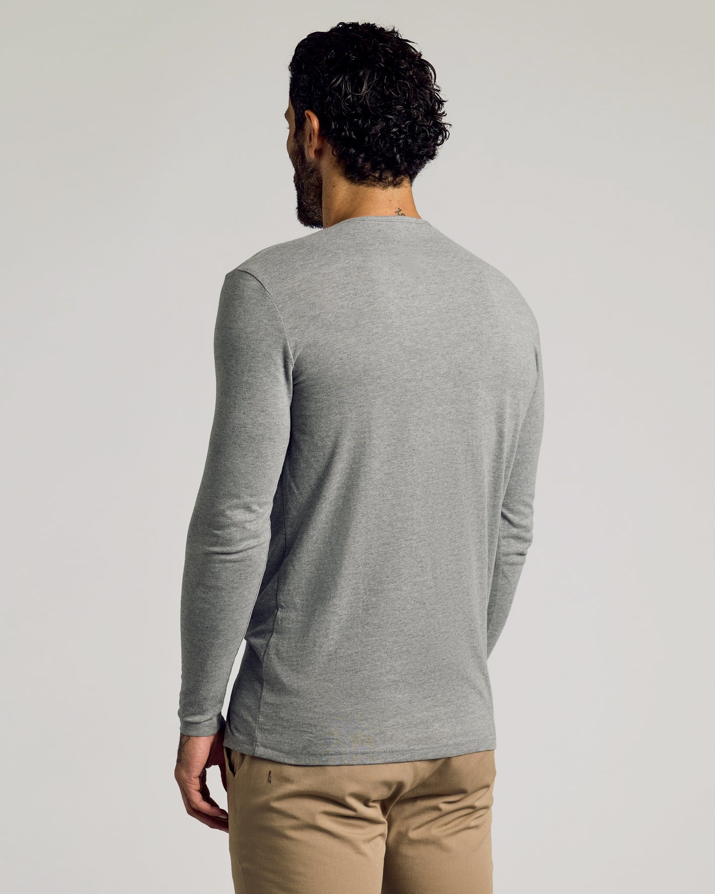 Man wearing Heather Gray Tall Classic Long Sleeve Henley, seen from behind.