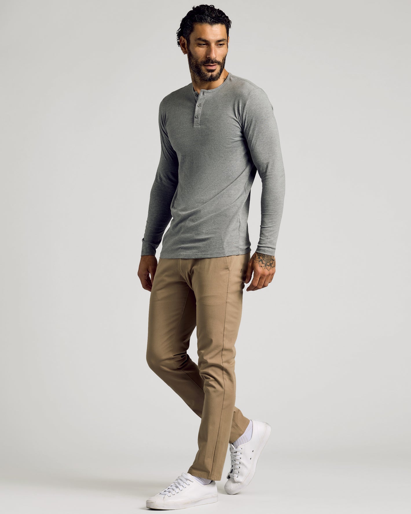 Man in Heather Gray Tall Classic Long Sleeve Henley, tan pants, white sneakers.