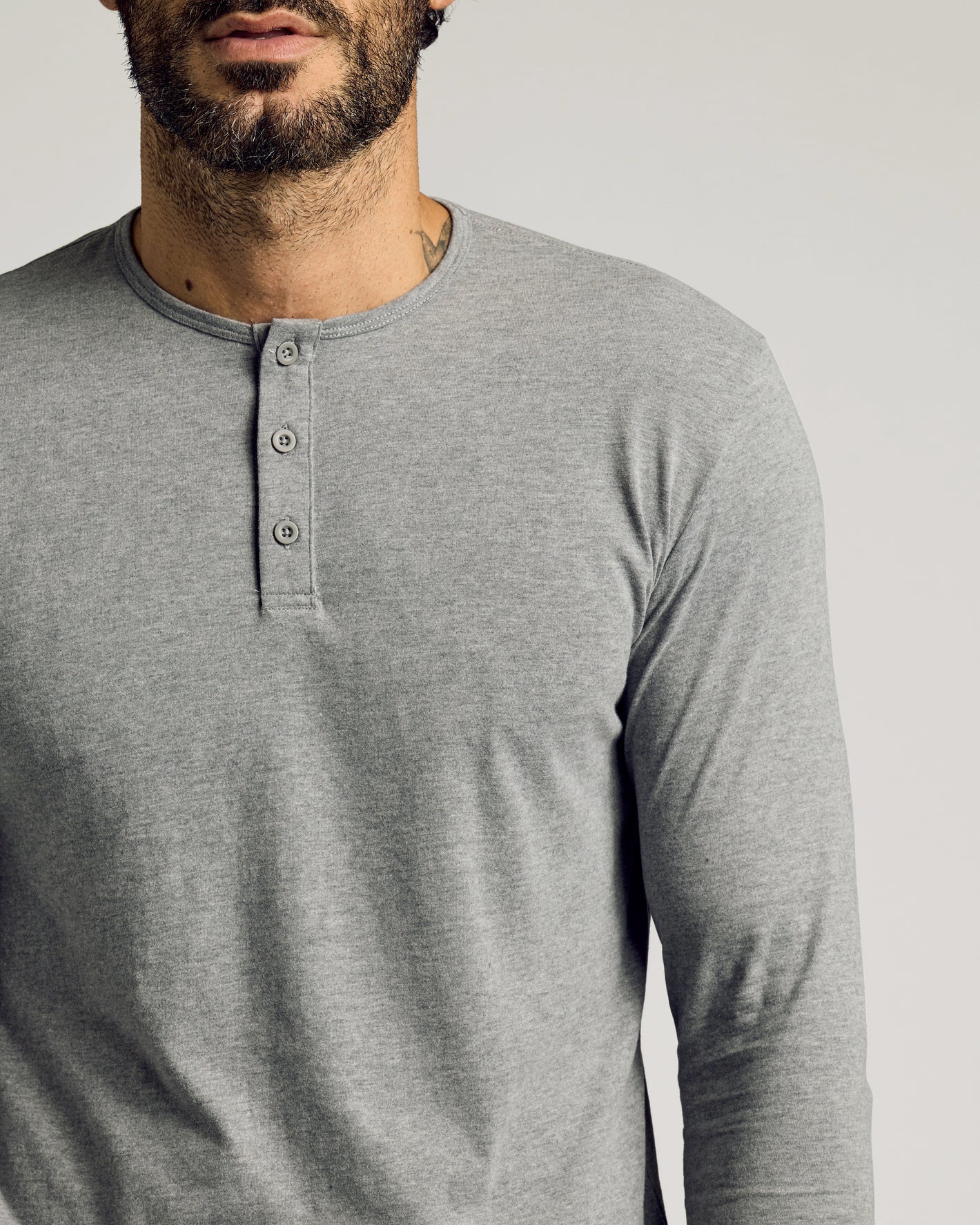 Man wearing Heather Gray Tall Classic Long Sleeve Henley, showcasing button placket.