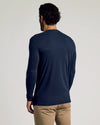 Man wearing Tall Classic Long Sleeve Henley, navy shirt, tan trousers.