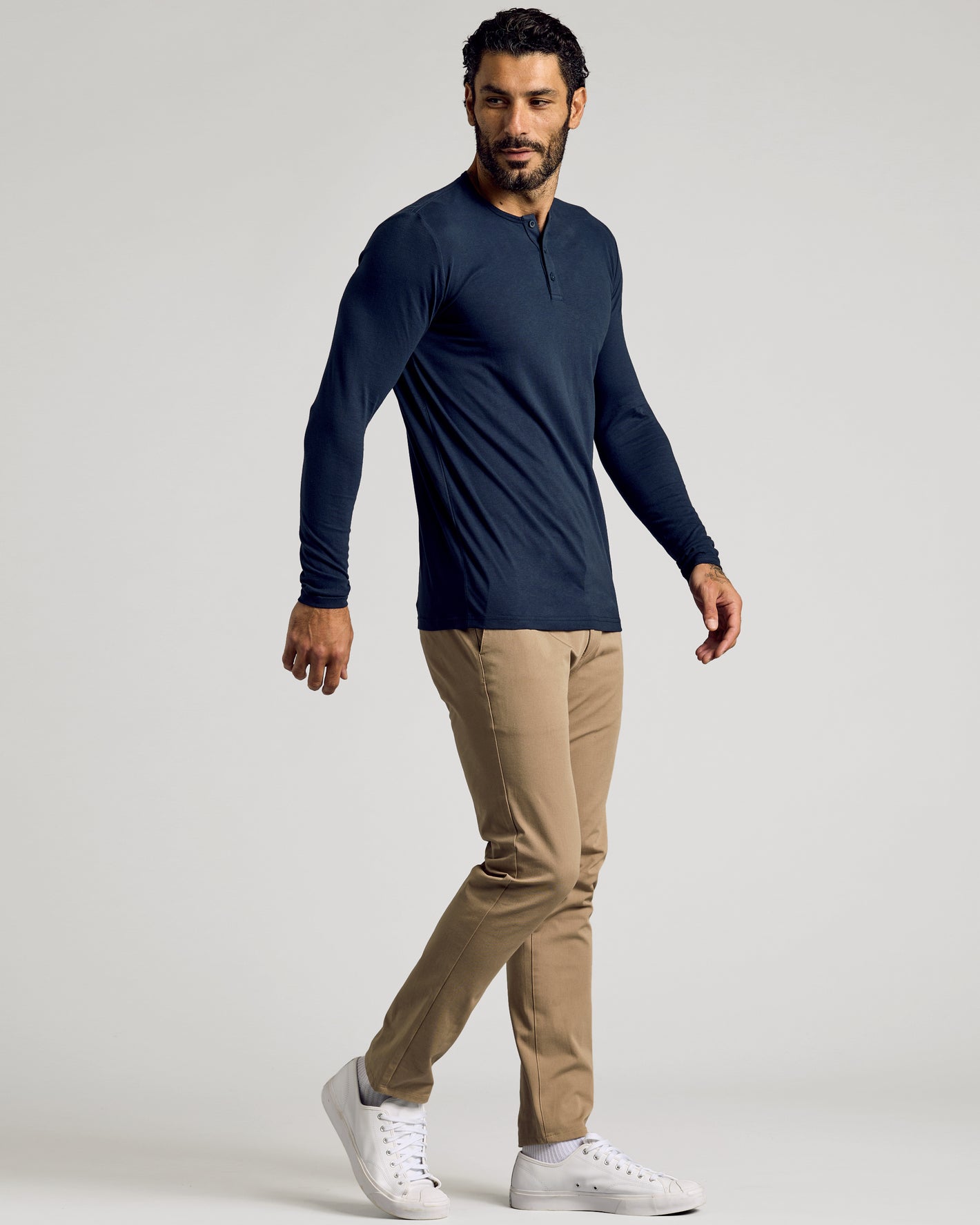 Man wearing Navy Long Sleeve Tall Classic Henley with chinos and sneakers.