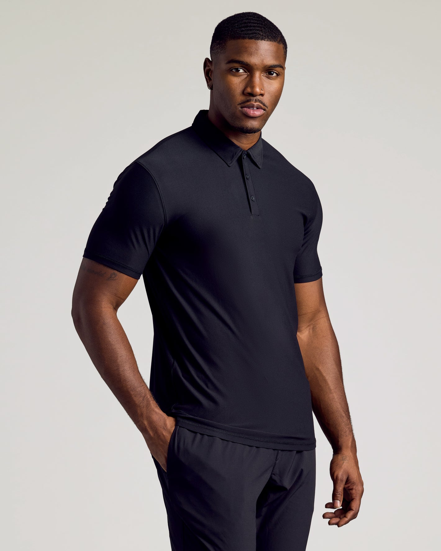 Timeless Tall Active Polo 3-Pack on model in fitted black attire.