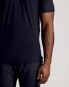Black Short Sleeve Tall Active Polo worn by person, showcasing snug fit.