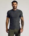 Man wearing Timeless Tall Active Polo, showcasing fitted style and tattooed forearm.