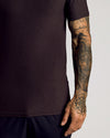 Dark Heather Cocoa Short Sleeve Tall Active Polo with tattooed arm detail.
