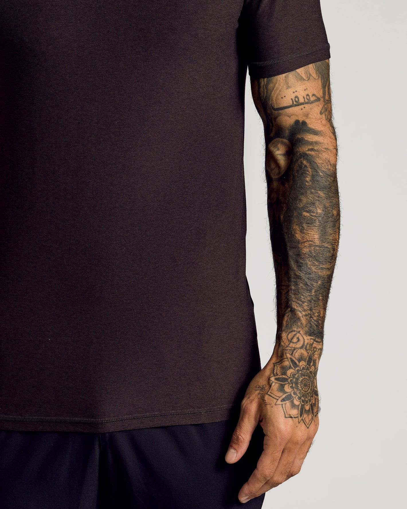 Dark Heather Cocoa Short Sleeve Tall Active Polo with tattooed arm detail.