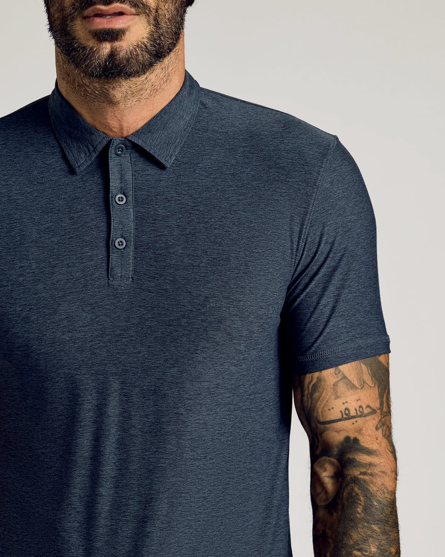 Man in navy Dark Heather Fiord Short Sleeve Tall Active Polo.