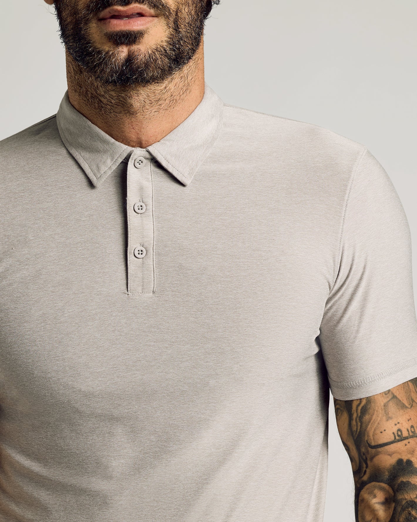 Man wearing Light Heather Gray Short Sleeve Tall Active Polo.