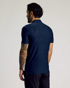 Man in Navy Short Sleeve Tall Active Polo, showcasing tattooed arm.