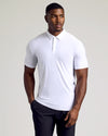 Athletic man wearing a white Tall Active Polo - Men's Performance Stretch Polo Shirt - Moisture Wicking Athletic Fit with short sleeves and a classic collar, paired with black pants.