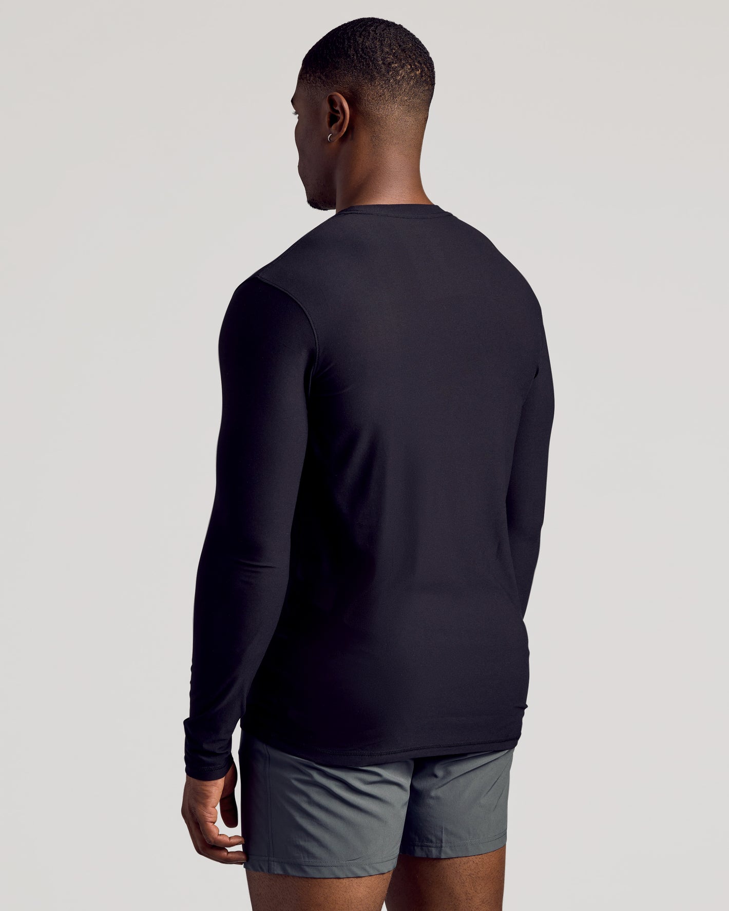 Man in Black Long Sleeve Tall Active Crew, gray athletic shorts.