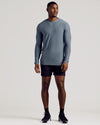 Man wearing Heather Navy Long Sleeve Tall Active Crew, black shorts, running shoes.