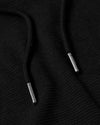 Black Tall Waffle Hoodie drawcords with silver metal aglets on textured fabric.