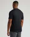 Rear view of a man wearing a black Tall Pima Cotton Blend Crew 7-Pack t-shirt, showcasing a clean, fitted style in essential men's basics.