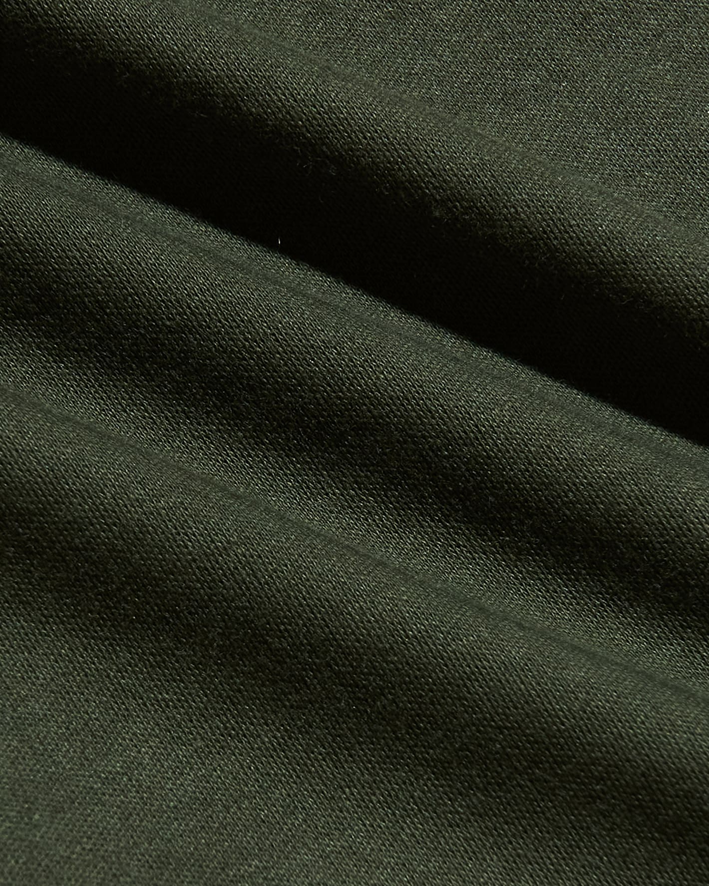 Close-up view of dark green soft fabric texture highlighting the smooth, high-quality material used in the Grove Tall Pima Cotton Blend Crew, a men's basics essential.