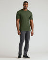 Man wearing an olive green crew neck t-shirt paired with gray pants and black sneakers, showcasing the Tall Pima Cotton Blend Crew 4-Pack as a versatile men's basics essential.