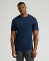 Male model wearing a navy blue Tall Pima Cotton Blend Crew 4-Pack T-shirt, showcasing a fitted, classic crew neck style for men's basics.