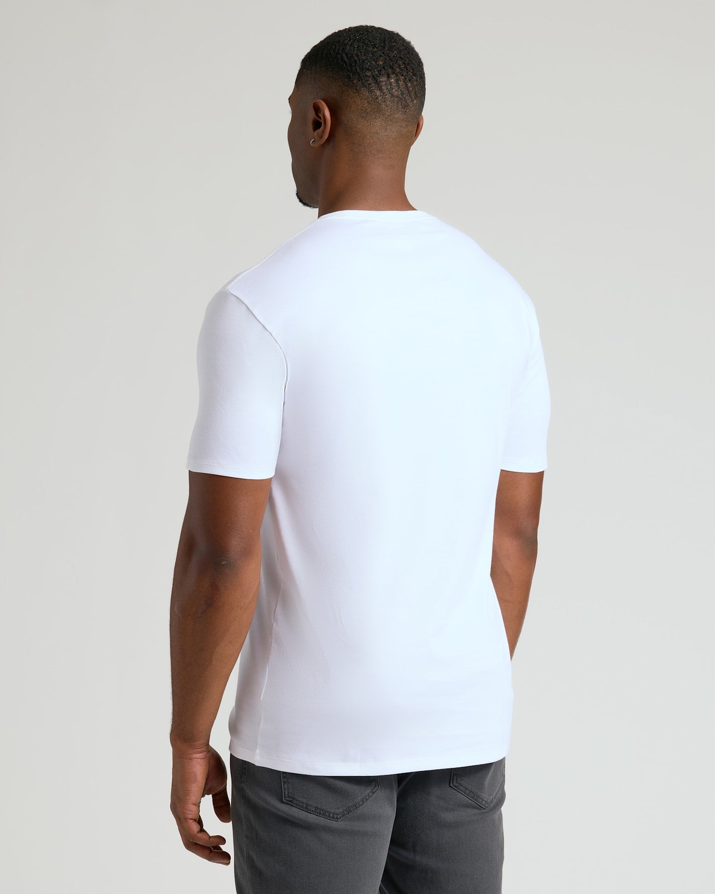 Man wearing a white Tall Pima Cotton Blend Crew 4-Pack T-shirt shown from the back, highlighting the smooth fabric and comfortable fit, ideal men's basics.