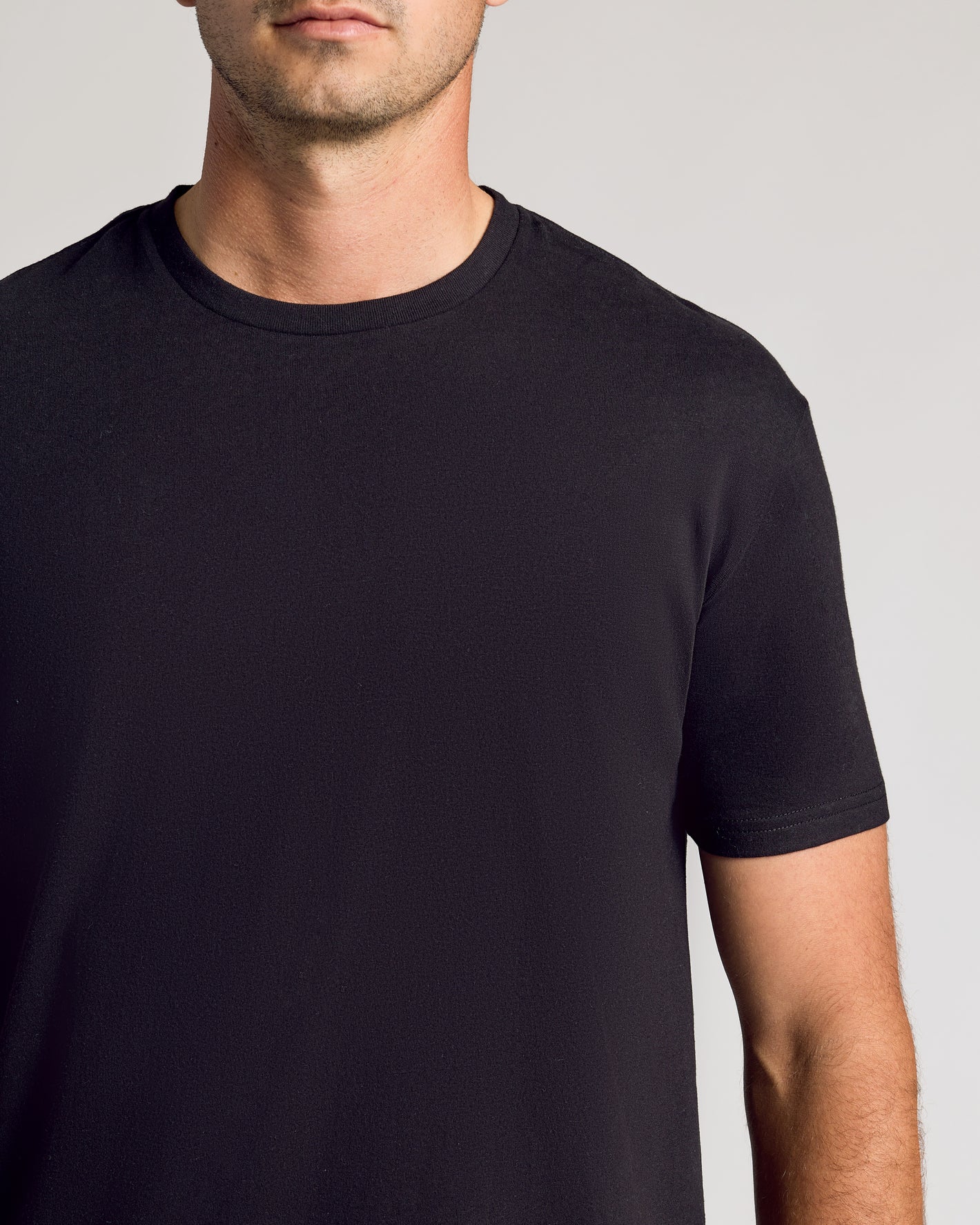 Black Short Sleeve Tall Curved Hem Crew on display, showcasing tailored fit.