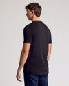 Man wearing Black Short Sleeve Tall Curved Hem Crew from behind.